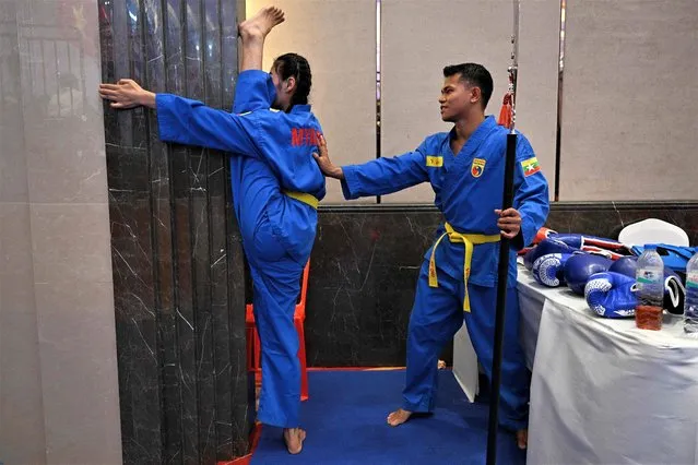 Members of Myanmar's vovinam team warm up before competing in the vovinam event at the 32nd Southeast Asian Games (SEA Games) in Phnom Penh on May 6, 2023. (Photo by Mohd Rasfan/AFP Photo)