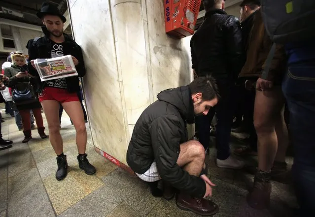 A participant takes his pants off as he prepares for “The No Pants Subway Ride” in Bucharest January 11, 2015. (Photo by Radu Sigheti/Reuters)