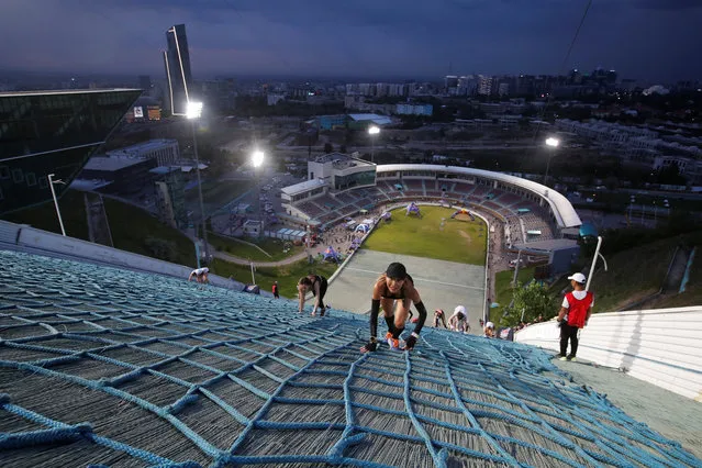 Athletes compete in the Red Bull 400 uphill sprint at the Sunkar international ski jumping complex in Almaty, Kazakhstan on May 13, 2023. (Photo by Pavel Mikheyev/Reuters)