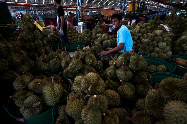 Durian vendors wait for customers at a market in Bangkok, Thailand, April 26, 2018. (Photo by Athit Perawongmetha/Reuters)