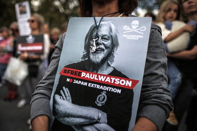 A protestor holds a sign displaying the portrait of the NGO Sea Shepherd Canadian founder Paul Watson during a demonstration in his support in Paris on September 4, 2024. US-Canadian Paul Watson, 73, was arrested on July 21, 2024 in Greenland under an Interpol “red notice” issued by Japan. A court hearing on his continued detention was due on September 4, 2024. (Photo by Thibaud Moritz/AFP Photo)