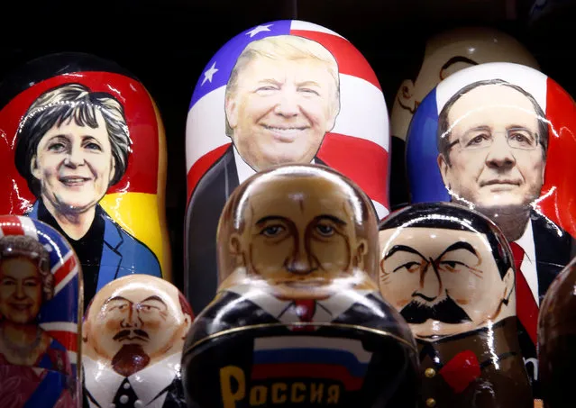 Painted Matryoshka dolls, or Russian nesting dolls, bearing the faces of German Chancellor Angela Merkel, U.S. Republican presidential nominee Donald Trump, French President Francois Hollande, Britain's Queen Elizabeth II, Soviet state founder Vladimir Lenin, Russian President Vladimir Putin and Soviet dictator Josef Stalin, are displayed for sale at a souvenir shop in central Moscow, Russia, November 7, 2016. (Photo by Sergei Karpukhin/Reuters)