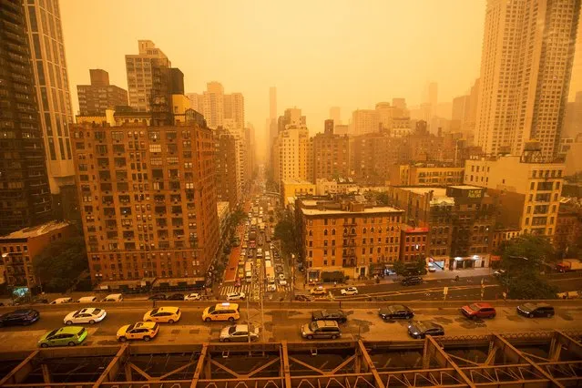 Traffic moves over the Ed Koch Queensboro Bridge as smoke from Canadian wildfires casts a haze over the area on June 7, 2023 in New York City. Air pollution alerts were issued across the United States due to smoke from wildfires that have been burning in Canada for weeks. (Photo by Eduardo Munoz Alvarez/Getty Images)