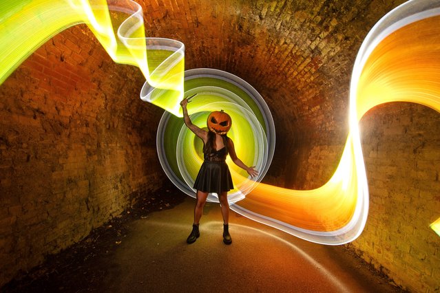 A halloween themed light painting photo featuring Jessica Astley in a Colchester tunnel in Essex, UK on October 25, 2024, using colourful LED lights moved about during a seven-second exposure. (Photo by Kevin Jay/Picture Exclusive)
