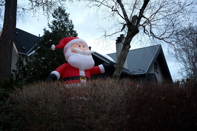 Inflatable Santa Claus decorations are seen on Inglewood Drive in Toronto, Ontario on December 11, 2024. Inglewood Drive neighbourhood put up 14-foot-tall inflatable Santas as a Christmas tradition since 2013. (Photo by Mert Alper Dervis/Anadolu via Getty Images)