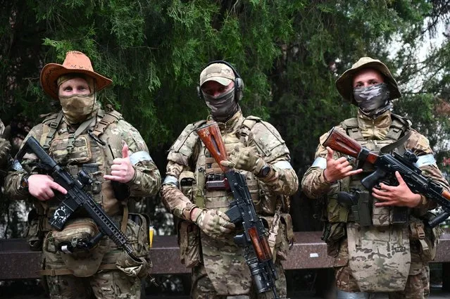 Fighters of Wagner private mercenary group pose for a picture as they get deployed near the headquarters of the Southern Military District in the city of Rostov-on-Don, Russia on June 24, 2023. (Photo by Reuters/Stringer)