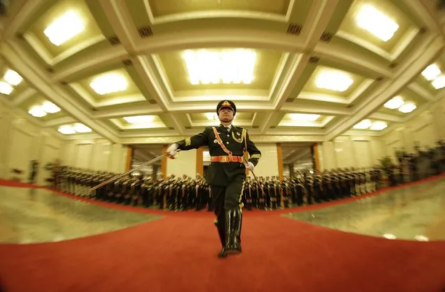 A military officer from the honour guards practises ahead of a welcoming ceremony for French Prime Minister Manuel Valls at the Great Hall of the People in Beijing January 29, 2015. (Photo by Jason Lee/Reuters)