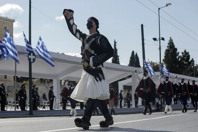 Members of the Greek army march with traditional costumes during a parade in Athens, Thursday, March 25, 2021. Fighter jets flew by the ancient Acropolis and tanks rumbled past parliament in central Athens as Greece's celebrations for the bicentenary of the nation's war of independence culminated in a military parade attended by dignitaries from Britain, France and Russia but no public. (Photo by Kostas Tsironis/Pool via AP Photo)