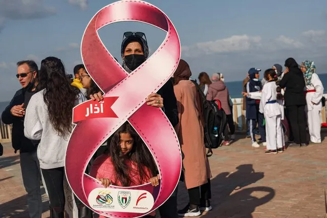 Palestinian women take part in a rally commemorating International Women's Day, organised by the Palestinian Federation for Sports Culture, along the seaside road in Gaza City on March 8, 2021. (Photo by Mohammed Abed/AFP Photo)