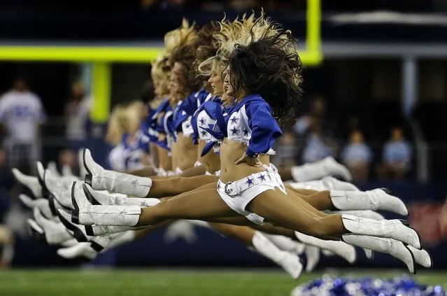 Members of the Dallas Cowboys cheerleaders perform before the Cowboys' preseason game against the Cincinnati Bengals in Arlington. (Photo by L. M. Otero/Associated Press)