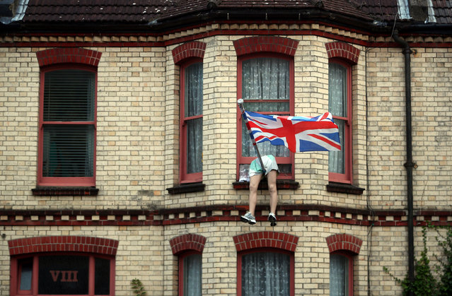 The legs of a mannequin hang out of the window of a house on a residential street in Brighton, Britain, September 18, 2018. (Photo by Hannah McKay/Reuters)