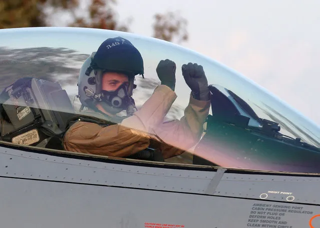 A Belgian pilot sits in his Belgian Air Force F16 fighter aircraft, which took part in an offensive in Libya, after landing at Araxos airbase, Greece March 28, 2011. A Libyan rebel spokesman said Muammar Gaddafi's hometown of Sirte had been captured by the rebels on Monday, but no independent verification of the statement was immediately available. (Photo by Yves Herman/Reuters)