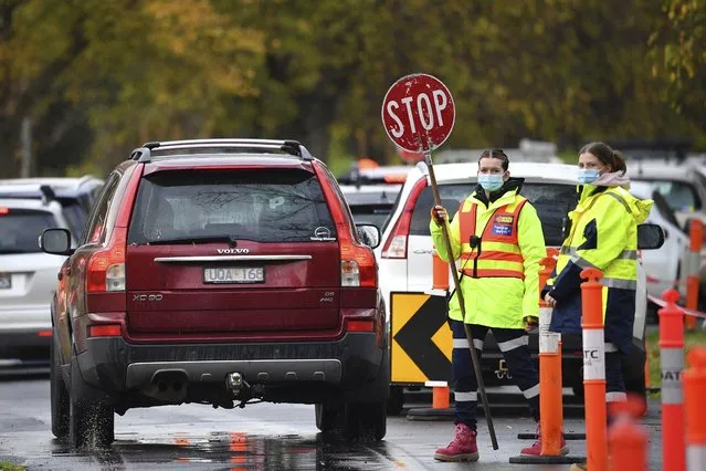 Traffic is controlled at a COVID-19 testing facility in Melbourne, Australia, Thursday, May 27, 2021, Australia’s second largest city announced a seven-day lockdown on Thursday as concern grows over dozens of cases of a COVID-19 variant found in India. (Photo by James Ross/AAP Image via AP Photo)