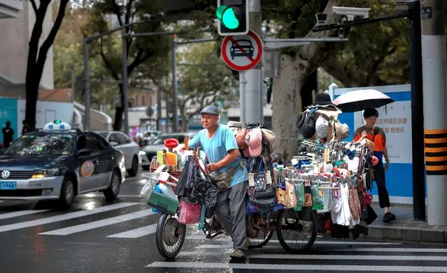 A man pushes a cargo bicycle while selling goods on the street, in Shanghai, China on September 14, 2023. China's unemployment rate fell to 5.2 percent in August 2023, from 5.3 percent in July, according to a report from the National Bureau of Statistics. Last month, China suspended releasing the youth unemployment rate data after six consecutive increases. The National Bureau of Statistics reported the surveys need further optimisation and improvement. (Photo by Alex Plavevski/EPA/EFE)