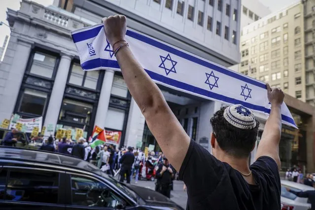 Hundreds of Palestinian and Israeli supporters gather outside of the Consulate of Israel in San Francisco on Sunday, October 8, 2023. (Photo by Bronte Wittpenn/San Francisco Chronicle via AP Photo)