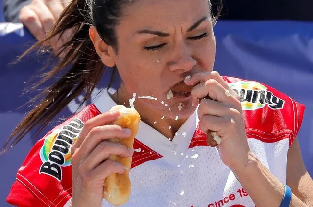 Michelle Lesco competes in the Women's Nathan's Famous Fourth of July Hot Dog Eating Contest, in Brooklyn, New York City, New York, U.S., July 4, 2021. (Photo by Andrew Kelly/Reuters)