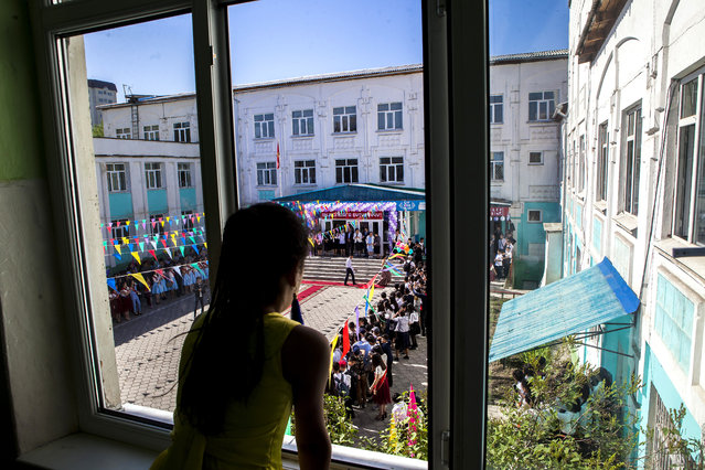 A girl watches a school graduation celebration on May 25, 2018 in Bishkek, Kyrgyzstan. (Photo by Beksultan Abibakir/Radio Free Europe/Radio Liberty)