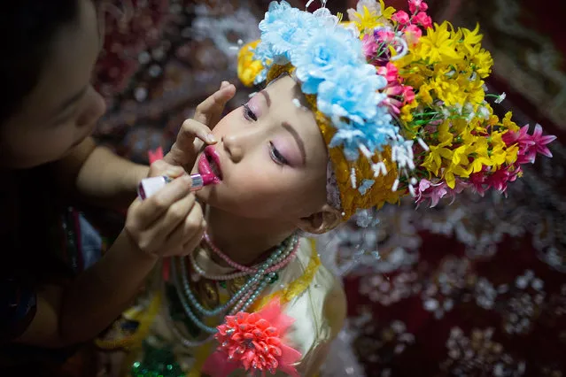 Relatives apply makeup to the face of a Tai Yai boy during the Poy Sang Long Festival on April 1, 2015 in Mae Hong Son, Thailand. Poy Sang Long is a Buddhist novice ordination ceremony of the Shan people or Tai Yai, an ethnic group of Shan State in Myanmar and northern Thailand. Young boys aged between 7 and 14 are ordained as novices to learn the Buddhist doctrines.  (Photo by Taylor Weidman/Getty Images)