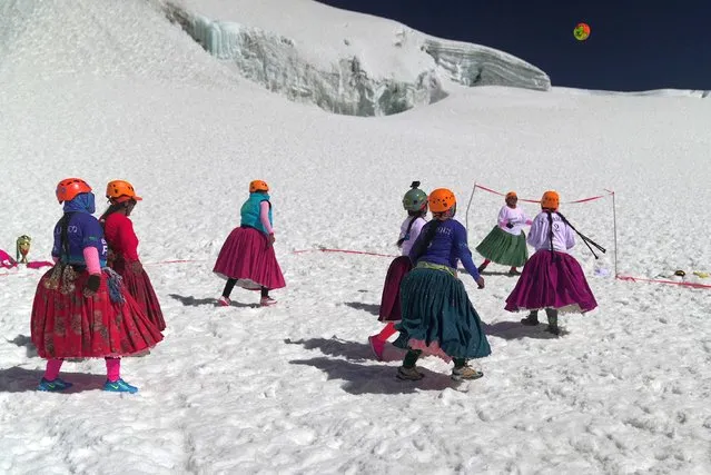 Aymara indigenous women members of the Climbing Cholitas of Bolivia Warmis play a football match at about 6.000 m, in the last flat area before making summit at the 6.088-metre Huayna Potosi mountain, near El Alto, Bolivia, on August 14, 2022. The Climbing Cholitas of Bolivia Warmis is a group dedicated to campaigning for the rights of indigenous women through mountaineering. (Photo by Martin Silva/AFP Photo)