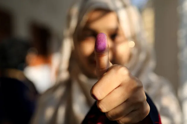 A woman displays her inked thumb after casting her vote for the general election in Dhaka, Bangladesh, December 30, 2018. Voting was underway Sunday in Bangladesh's contentious parliamentary elections, seen as a referendum on what critics call Prime Minister Sheikh Hasina's increasingly authoritarian rule, amid complaints from both ruling party and opposition activists of attacks on supporters and candidates. (Photo by Mohammad Ponir Hossain/Reuters)