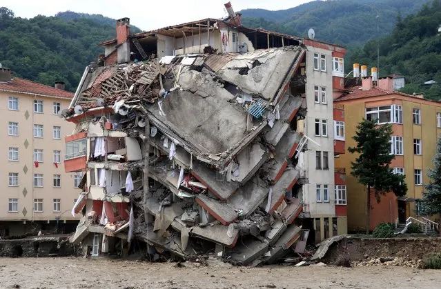 Search and rescue works are being carried in a residental building collapsed due to the floods caused by heavy rains in Bozkurt district of Kastamonu, Turkey on August 12, 2021. (Photo by Cihan Okur/Anadolu Agency via Getty Images)