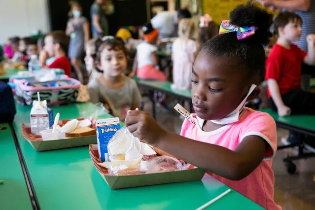 A student takes away her mask as she eats lunch at Wilder Elementary School in Louisville, KY, Kentucky, U.S., August 11, 2021. (Photo by Amira Karaoud/Reuters)