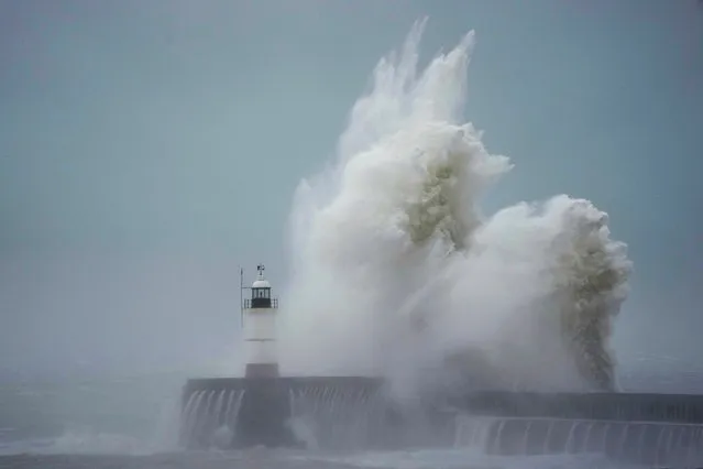 Waves crash over Newhaven Lighthouse and the harbour wall in Newhaven, southern England, Thursday, November 2, 2023. Winds up to 180 kilometers per hour (108 mph) slammed France's Atlantic coast overnight as Storm Ciaran lashed countries around western Europe, uprooting trees, blowing out windows and leaving 1.2 million French households without electricity Thursday. Strong winds and rain also battered southern England and the Channel Islands, where gusts of more than 160 kph (100 mph) were reported. (Photo by Kin Cheung/AP Photo)