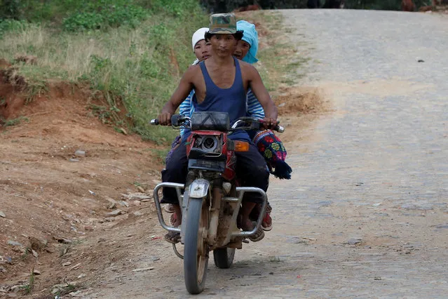 People ride their motorbike as they travel outside Panghsang capital city of ethnic Wa territory in northeast Myanmar October 3, 2016. (Photo by Soe Zeya Tun/Reuters)