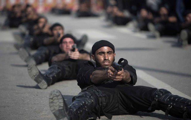 Hamas security forces show their skills during a military parade in Gaza city on January 13, 2014, marking the fifth anniversary of the three-week Israeli offensive on the Gaza Strip in which more than a thousand Palestinians were killed between the late 2008 and early 2009. (Photo by Mahmud Hams/AFP Photo)