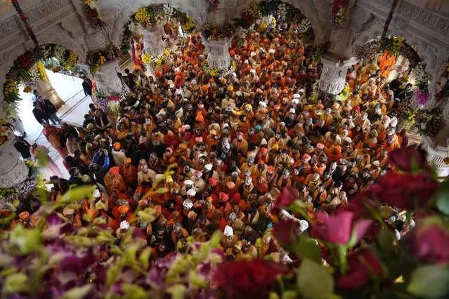 Hindu holy men throng to get the first look of the temple dedicated to Hinduism’s Lord Ram soon after its inauguration in Ayodhya, India, Monday, January 22, 2024. Indian Prime Minister Narendra Modi opened the controversial Hindu temple built on the ruins of a historic mosque in the holy city of Ayodhya in a grand event that is expected to galvanize Hindu voters in upcoming elections. (Photo by Rajesh Kumar Singh/AP Photo)