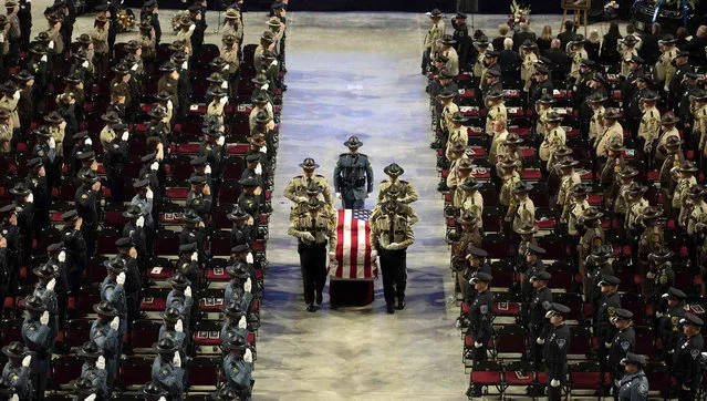 Hancock County Sheriff's deputies escort the flag-draped casket of Sheriff's Deputy Luke Gross out of the Cross Insurance Center during a funeral service, Thursday, September 30, 2021, in Bangor, Maine. Gross, 44, a veteran Hancock County sheriff’s deputy, was struck and killed by a pickup truck while responding to a car crash in Trenton on Sept. 23. (Photo by Linda Coan O'Kresik/The Bangor Daily News via AP Photo)