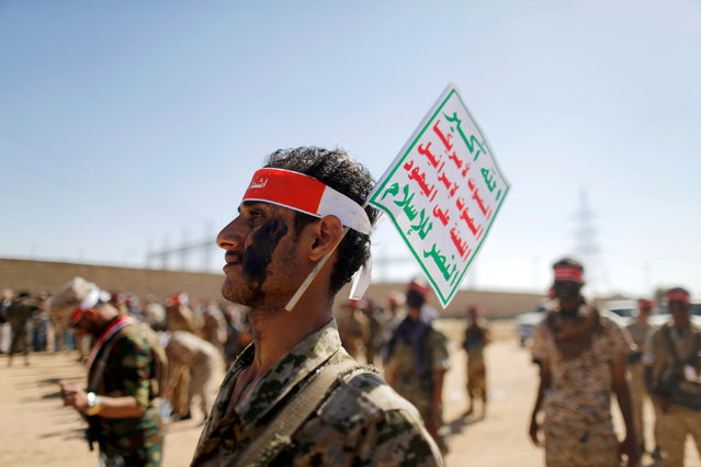 Newly recruited Houthi fighters take part in a parade before heading to the battle front to fight against government forces in Sanaa, Yemen, February 1, 2017. The flag reads: “Allah is the greatest. Death to America, death to Israel, a curse on the Jews, victory to Islam”. (Photo by Khaled Abdullah/Reuters)