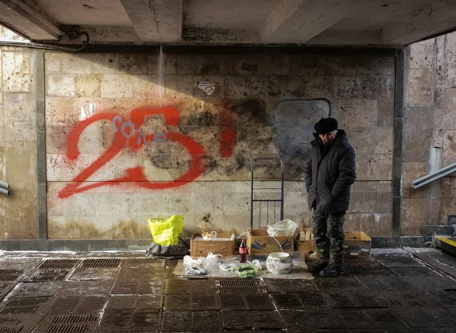 A man waits for customers as he sells home-made products on a winter day in an underpass in central Kiev, Ukraine on January 9, 2019. (Photo by Gleb Garanich/Reuters)