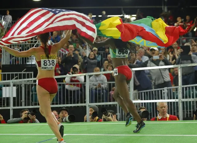 Gold medalist Genzebe Dibaba of Ethiopia (R) and Bronze medalist Shannon Rowbury of the U.S. run with their country's flags after the women's 3000 meters during the IAAF World Indoor Athletics Championships in Portland, Oregon March 20, 2016. (Photo by Mike Blake/Reuters)