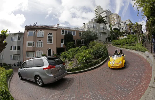 Cars make their way down Lombard Street in San Francisco, Monday, April 15, 2019. Thousands of tourists may soon have to pay as much as $10 to drive down the world-famous crooked street if a proposal announced Monday becomes law. In the summer months, an estimated 6,000 people a day visit the 600-foot-long street, creating lines of cars that stretch for blocks. (Photo by Eric Risberg/AP Photo)