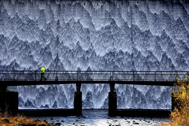 A maintenance worker crosses the bridge at Wet Sleddale Reservoir in Penrith, Britain on November 3, 2023. (Photo by Lee Smith/Reuters)