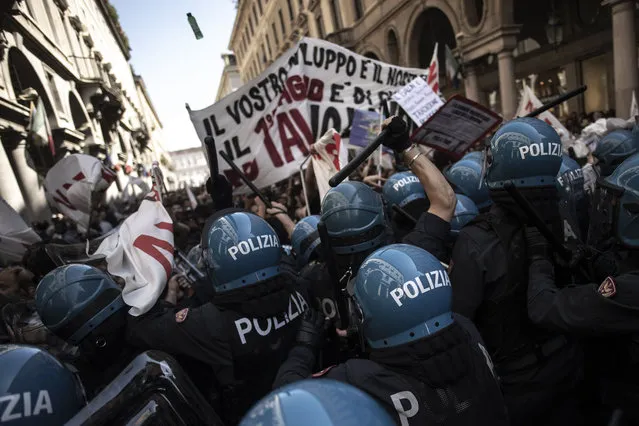 Riot police clash with protesters of the No Tav movement (against the Turin–Lyon high-speed TAV railway line) in Turin, during one of several demonstrations against unemployment as part of May Day rallies on May 1, 2019. (Photo by Marco Bertorello/AFP Photo)