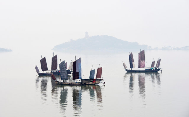Boats rest on the lake in morning fog in Wuxi, eastern China on April 15, 2019. (Photo by Pan Zhengguang/Xinhua News Agency/Barcroft Images)