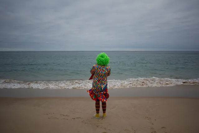 A carnival reveller stands on the beach during the clowns parade in Sesimbra village, Portugal, February 27, 2017. (Photo by Pedro Nunes/Reuters)