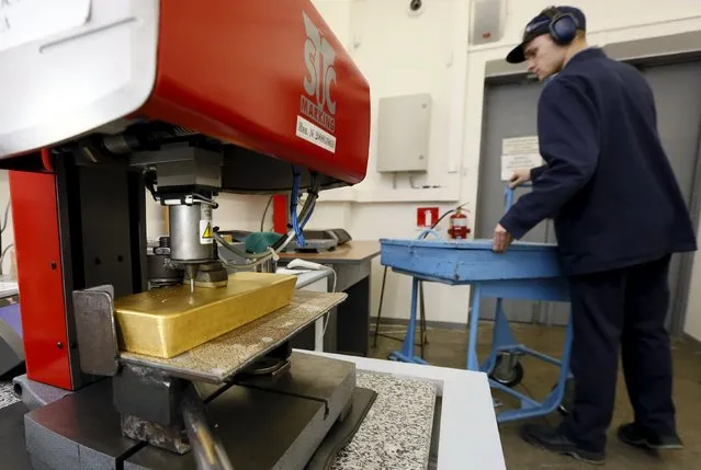 A machine is used to engrave information on an ingot of 99.99 percent pure gold at the Krastsvetmet Krasnoyarsk non-ferrous metals plant in the Siberian city of Krasnoyarsk, Russia, June 5, 2015. Krastsvetmet is one of the world's largest players in the precious metals industry. REUTERS/Ilya Naymushin