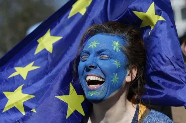 A demonstrator with her face painted inthe colours of the EU flag participates in an anti Brexit, pro-European Union (EU) march in London on March 25, 2017, ahead of the British government's planned triggering of Article 50 next week. Britain will launch the process of leaving the European Union on March 29, setting a historic and uncharted course to become the first country to withdraw from the bloc by March 2019. (Photo by AFP Photo/APA)