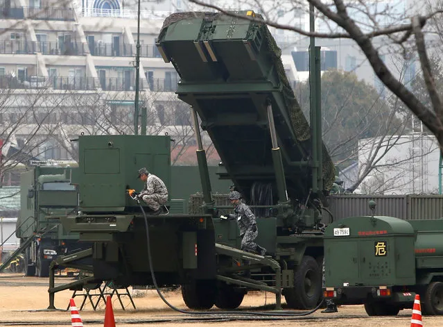 Japan Self-Defense Forces soldiers inject fuels into a unit of Patriot Advanced Capability-3 (PAC-3) missiles at the Defense Ministry in Tokyo, Japan, March 6, 2017. (Photo by Kim Kyung-Hoon/Reuters)