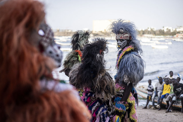 Performers play in traditional costumes during the famous Fake Lion Show at a cultural event at Ngor beach in Dakar, on June 5, 2024. (Photo by John Wessels/AFP Photo)