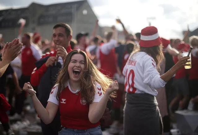 Denmark fans celebrate as they watch their Euro match against Wales, in Copenhagen on June 26, 2021. (Photo by Hannah Mckay/Reuters)