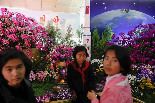 A model of a rocket is displayed as people visit the flower exhibition marking the 105th birth anniversary of the country's founding father, Kim Il Sung in Pyongyang, North Korea April 16, 2017. (Photo by Damir Sagolj/Reuters)