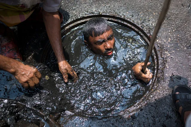 A sewer cleaner of Dhaka City Corporation cleaning out the city's sewers on May 03, 2017 in Dhaka, Bangladesh. (Photo by Zakir Chowdhury/Barcroft Images)