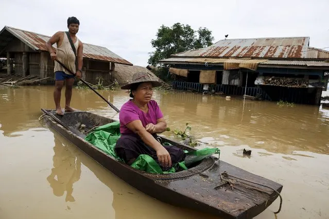 A man rows his boat along a flooded street at a village in Kawlin township, Sagaing division, Myanmar July 21, 2015. (Photo by Soe Zeya Tun/Reuters)