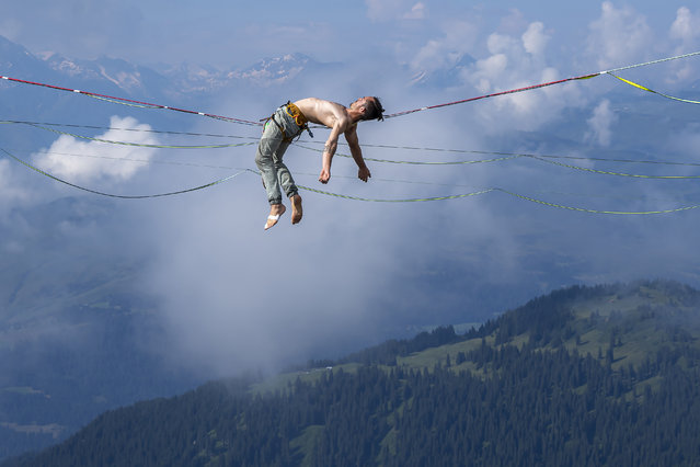 Clement Droy from France performs during the warm up at the Highline World Championships on the summit of Crap Sogn Gion in Laax, Switzerland, 19 July 2024. The World Championships in highlining are held in Laax, Switzerland from 17 until 21 July 2024. (Photo by Yanik Buerkli/EPA/EFE)