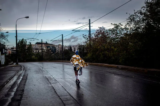 A runner walks outside the Panathenaic stadium after finishing the 37th Athens Classic Marathon in Athens on November 10, 2019. Kenyan John Kipkorir Komen won the 37th Athens Classic Marathon on November 10, 2019, clocking two hours, 16 minutes and 34 seconds in the rain. The women’s race was won by Greek Eleftheria Petroulaki clocking 2:45.50. (Photo by Angelos Tzortzinis/AFP Photo)