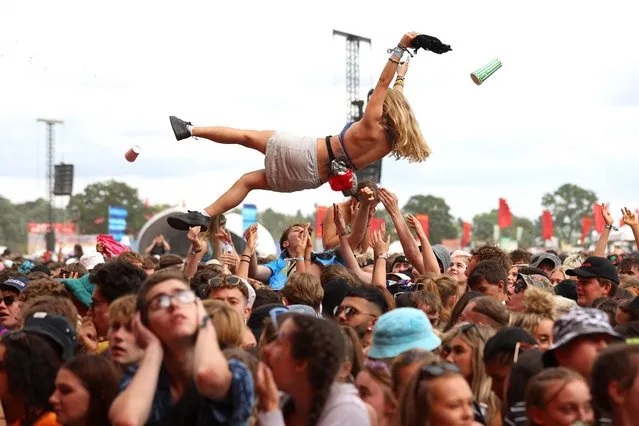 A festival goer is thrown up in the air above the crowd during Reading Festival 2021 at Richfield Avenue on August 28, 2021 in Reading, England. (Photo by Simone Joyner/Getty Images)